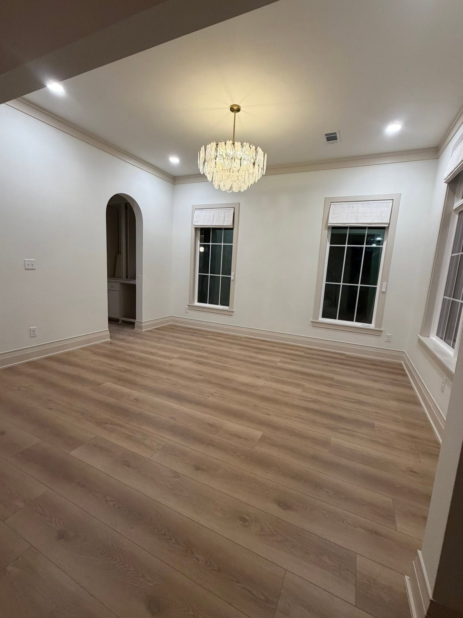 Final clean — elegant dining room with hardwood floors and chandelier